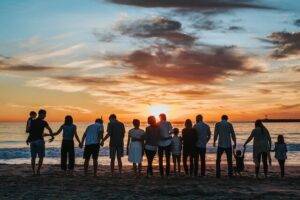 Family black magic, family standing in front of ocean.