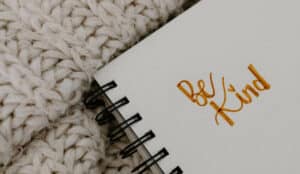 Spiritual Affirmations written in a book that says " Be kind".