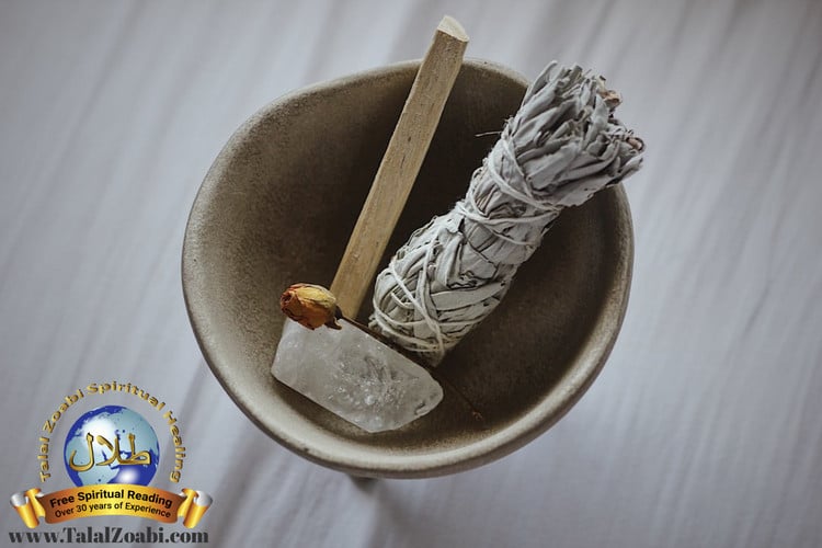 Spiritual cleansing, sage and a crystal in a wooden bowl.