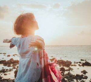 Spiritual healing, woman standing in the sun.