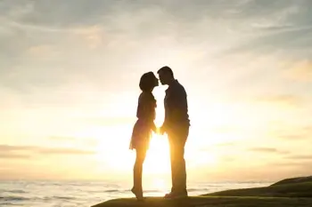 Helping life situations, man and woman kissing in sunset.