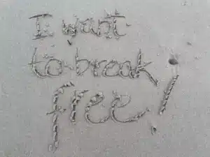 How to get over someone, I want to break free written in the sand.