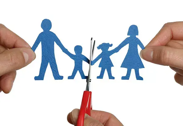 Family black magic, blue paper family holding hands getting cut in half by red scissors.