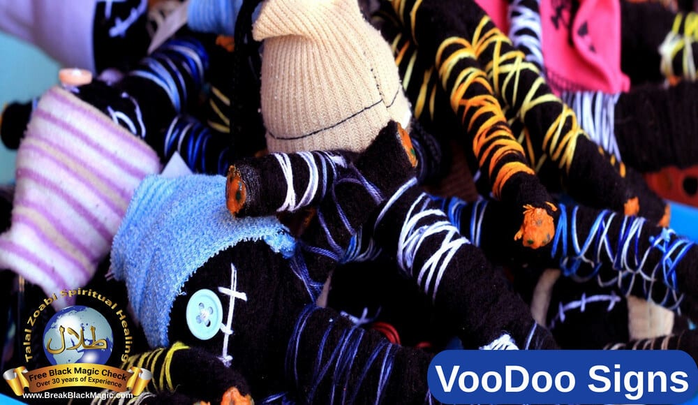 Voodoo signs, many black voodoo dolls with hats.