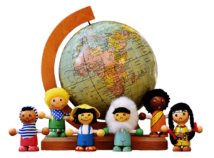 Multi culture dolls standing in front of a globe needing denotations for black magic removal.