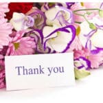 Card that says thank you on it with flowers behind it, spiritual healing testimonial.