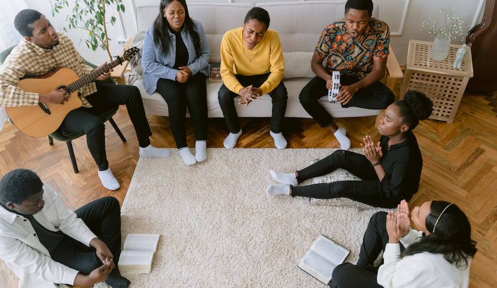 A family sitting doing a cleansing prayer for their home.