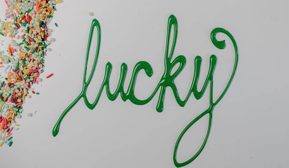 How to get lucky written in green frosting next to sprinkles.