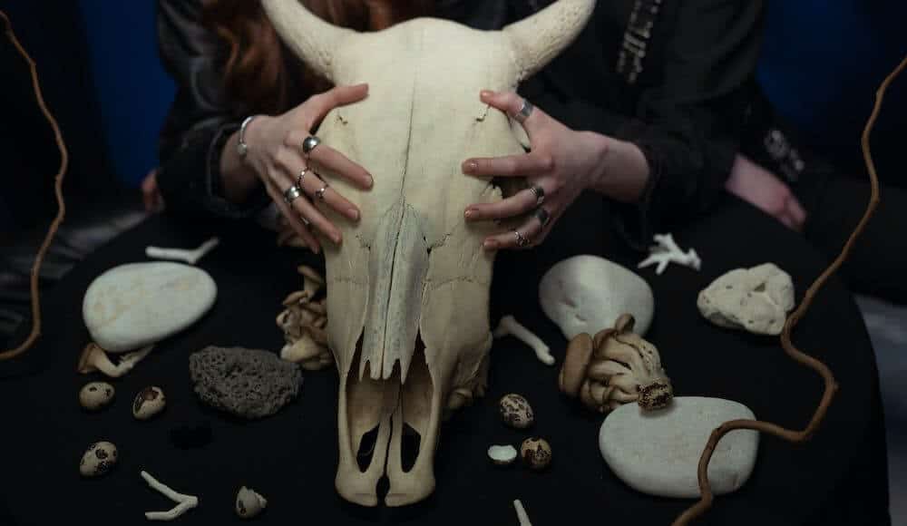 Witch holding a bull skull. Types of black magic.