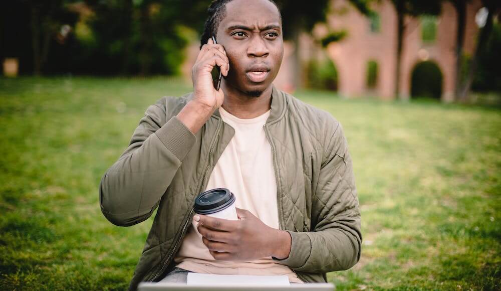 A man on the phone learning what causes bad luck in life.