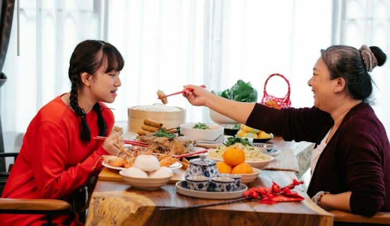 Mother and daughter sitting at table eating discussing how to remove a curse.